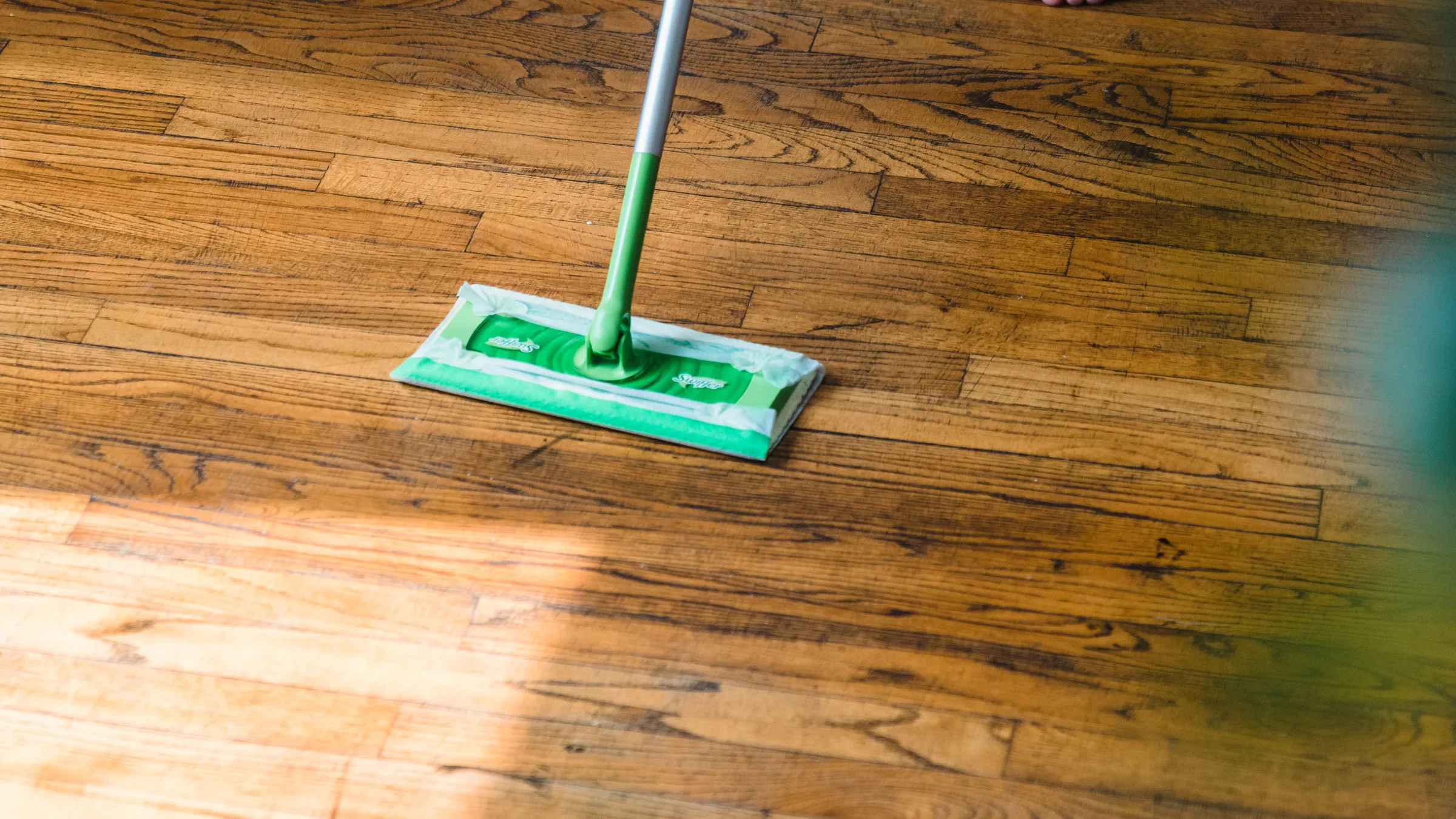 Mopping a hardwood floor during a home cleaning